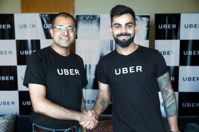 Amit Jain President Uber India SA with Uber India's Brand Ambassador Virat Kohli Captain Indian Cricket Team